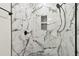 Modern shower with marble-like tile, dual shower heads, and built-in niche at 1045 Jesse Ave, Safety Harbor, FL 34695