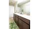 Bathroom with double sinks, dark wood cabinets, and a shower-tub combination at 10943 Verawood Dr, Riverview, FL 33579