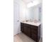Bathroom features a well-lit mirror, wood cabinets, and a white countertop with sink at 10943 Verawood Dr, Riverview, FL 33579