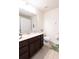 Bathroom featuring double sinks, dark wood cabinets, and a shower-tub at 10943 Verawood Dr, Riverview, FL 33579