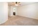 Spacious bedroom with carpet flooring, neutral walls, ceiling fan, and an ensuite bathroom at 10943 Verawood Dr, Riverview, FL 33579