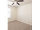 A neutral-colored carpeted bedroom features a ceiling fan, window with blinds, and bright walls at 10943 Verawood Dr, Riverview, FL 33579