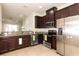 Kitchen with stainless steel appliances, dark cabinetry, and granite countertops at 10943 Verawood Dr, Riverview, FL 33579