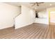 Open-concept living room featuring wood floors, staircase, and a view into the kitchen at 10943 Verawood Dr, Riverview, FL 33579
