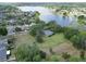 Aerial view of a home with a large yard, bordering a serene lake at 1204 Joe Henry Wheeler Dr, Dover, FL 33527