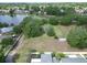 Aerial view showcasing a lakefront community with lush greenery, serene lake views, and residential homes nestled among trees at 1204 Joe Henry Wheeler Dr, Dover, FL 33527