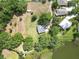 Aerial view showing a home with a vast lot, mature trees, and proximity to a tranquil lake and lush greenery at 1204 Joe Henry Wheeler Dr, Dover, FL 33527