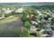 Aerial shot of a lakeside property with mature trees and surrounding neighborhood at 1204 Joe Henry Wheeler Dr, Dover, FL 33527