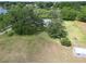 Aerial view of a charming home nestled among lush trees and expansive green lawn, offering a private, serene setting at 1204 Joe Henry Wheeler Dr, Dover, FL 33527