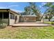 Backyard patio features exterior door with flower baskets in this cozy outdoor space, perfect for enjoying the weather at 1204 Joe Henry Wheeler Dr, Dover, FL 33527
