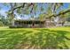 Beautiful backyard featuring a screened porch and a landscaped patio area, perfect for outdoor entertaining and relaxation at 1204 Joe Henry Wheeler Dr, Dover, FL 33527