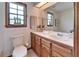 Well-lit bathroom with a single sink vanity, toilet, and tiled floors at 1204 Joe Henry Wheeler Dr, Dover, FL 33527