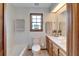 Well-lit bathroom with a single sink vanity, toilet, and tub with tiled surround at 1204 Joe Henry Wheeler Dr, Dover, FL 33527