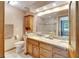 Well-lit bathroom with a double sink vanity, granite countertop, tiled floors, and a glass door shower at 1204 Joe Henry Wheeler Dr, Dover, FL 33527
