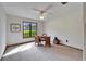 Bright bedroom featuring a window, ceiling fan, and simple furnishings for a serene atmosphere at 1204 Joe Henry Wheeler Dr, Dover, FL 33527