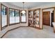 Breakfast nook with bright bay window and wooden shelving at 1204 Joe Henry Wheeler Dr, Dover, FL 33527