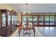 Dining area featuring a large cabinet and glass doors that offer nice outdoor views at 1204 Joe Henry Wheeler Dr, Dover, FL 33527