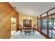 Dining room with wood paneling, chandelier, and doors leading to the outside at 1204 Joe Henry Wheeler Dr, Dover, FL 33527