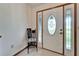Bright entryway with decorative front door, sidelights, and a small chair with a decorative sign at 1204 Joe Henry Wheeler Dr, Dover, FL 33527