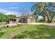 Home exterior with a brick patio, green lawn, a two-car garage, and a view of the front yard at 1204 Joe Henry Wheeler Dr, Dover, FL 33527