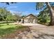 Charming home exterior with green lawn, and a concrete driveway leading to a two-car garage at 1204 Joe Henry Wheeler Dr, Dover, FL 33527
