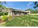 Charming home exterior features stone accents, dark shutters, and a well-manicured lawn at 1204 Joe Henry Wheeler Dr, Dover, FL 33527