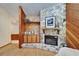 Stone fireplace with built-in shelving and wood paneling details in a cozy living room setting at 1204 Joe Henry Wheeler Dr, Dover, FL 33527