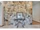 Elegant foyer with a striking stone accent wall, a glass table with artwork, and tile flooring at 1204 Joe Henry Wheeler Dr, Dover, FL 33527