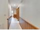 Well-lit hallway with classic wood trim and neutral walls lead to the bathroom and other living spaces at 1204 Joe Henry Wheeler Dr, Dover, FL 33527