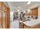 Well-lit kitchen features wood cabinetry, stainless steel appliances, and an open dining area at 1204 Joe Henry Wheeler Dr, Dover, FL 33527
