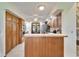 Kitchen with wood cabinets and a breakfast bar opening to the breakfast nook at 1204 Joe Henry Wheeler Dr, Dover, FL 33527