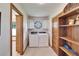 This laundry room is equipped with modern washer and dryer units plus additional storage at 1204 Joe Henry Wheeler Dr, Dover, FL 33527