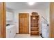 Functional laundry room offers a utility sink, cabinetry, and a convenient water heater at 1204 Joe Henry Wheeler Dr, Dover, FL 33527