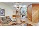 Comfortable living room with stone fireplace, wood paneling, hardwood floors, and cozy seating arrangements at 1204 Joe Henry Wheeler Dr, Dover, FL 33527