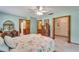 Bright main bedroom features tile floors, dresser and access to bathroom and closet at 1204 Joe Henry Wheeler Dr, Dover, FL 33527