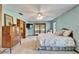 Spacious main bedroom features tile floors, dresser and access to a private patio at 1204 Joe Henry Wheeler Dr, Dover, FL 33527