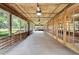Expansive wooden porch with ceiling fans, wood ceiling, and multiple access points to the interior at 1204 Joe Henry Wheeler Dr, Dover, FL 33527