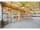Large covered porch featuring wood ceiling, ceiling fans, wall sconces, and plenty of space for furniture at 1204 Joe Henry Wheeler Dr, Dover, FL 33527