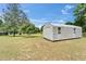 Exterior photo of a metal storage shed located on the property's expansive lawn at 1204 Joe Henry Wheeler Dr, Dover, FL 33527