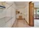 Spacious walk-in closet with wire shelving, carpet, and a glimpse of natural light from an adjacent room at 1204 Joe Henry Wheeler Dr, Dover, FL 33527