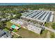 An aerial view of a condo community with a pool surrounded by verdant foliage and a serene atmosphere at 12300 Park Blvd # 202, Seminole, FL 33772