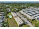 Aerial view of condo building with parking and a lush green landscape in a community at 12300 Park Blvd # 202, Seminole, FL 33772