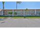 Multi-Gathering building with reserved parking and manicured landscaping under a bright blue sky at 12300 Park Blvd # 202, Seminole, FL 33772