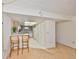 Compact kitchen featuring essential appliances, light wood cabinets, and a breakfast bar with seating at 12300 Park Blvd # 202, Seminole, FL 33772