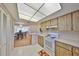 Functional kitchen providing direct access to dining room and featuring white tile floors at 12300 Park Blvd # 202, Seminole, FL 33772