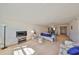 Bright living room featuring neutral carpeting and furniture, with an open floor plan to the dining area at 12300 Park Blvd # 202, Seminole, FL 33772