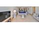 A well-lit living room with plush carpeting, showcasing comfortable seating and access to the dining area at 12300 Park Blvd # 202, Seminole, FL 33772