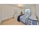 Cozy bedroom featuring a comfortable bed, dresser, and a window providing natural light at 12300 Park Blvd # 202, Seminole, FL 33772