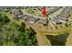 An aerial shot shows the property's location with a pond in a quiet residential neighborhood at 12308 Chaya Ct, Spring Hill, FL 34610