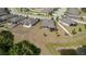 Aerial view of a home and its lot, bordering a pond with nearby homes and landscaping at 12308 Chaya Ct, Spring Hill, FL 34610
